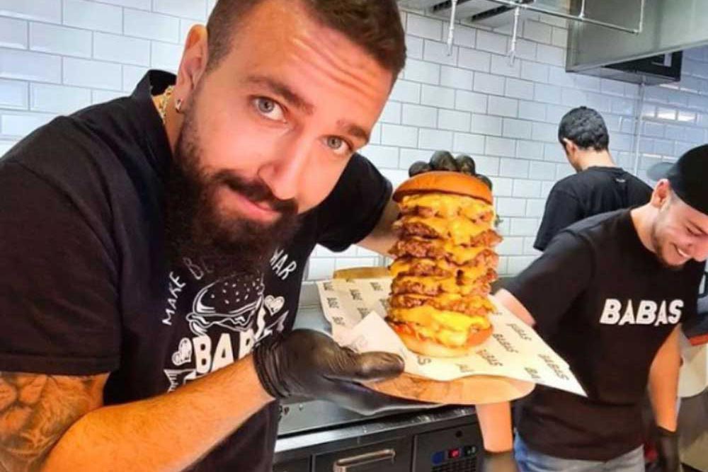Personal på BABAS håller upp en burgare
